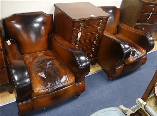 Two brown leather upholstered armchairs